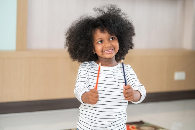 African American girl holding a pencil School Nerd Excited Black Schoolgirl Holding Pencil