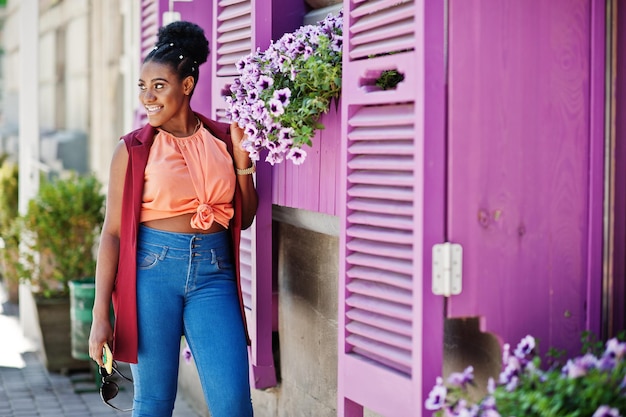 African american girl posed against purple windows outdoor