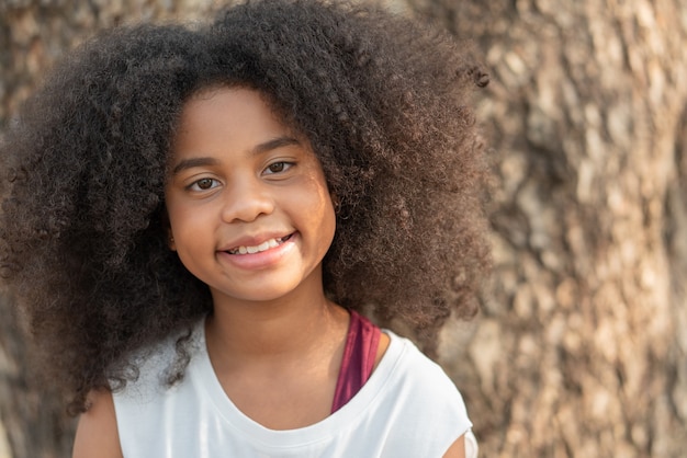 African American girl smiling and looking at camera in the park