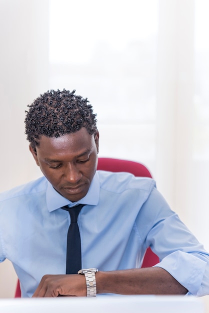 African American handsome Businessman looking at the time on his watch