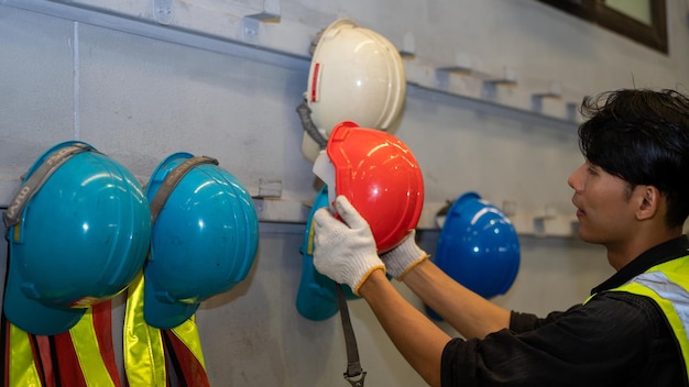 African American holding Safety Helmet Safety helmet equipment in Manufacturing Factory site