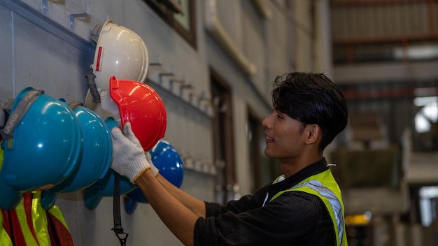 African American holding Safety Helmet Safety helmet equipment in Manufacturing Factory site