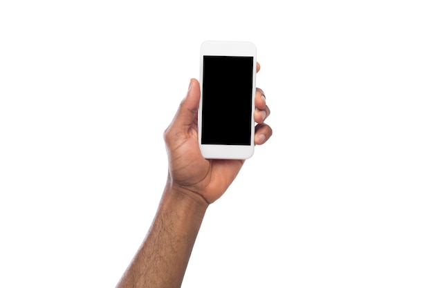 African-american male hand holding mobile smartphone with blank screen, isolated on white background. Copy space for advertisement of mobile app, mockup