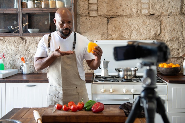 African American man in his home kitchen making content for his influencer channel