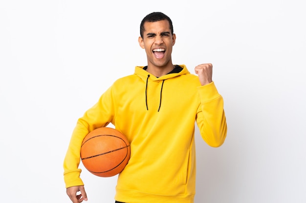 African American man over isolated white background playing basketball