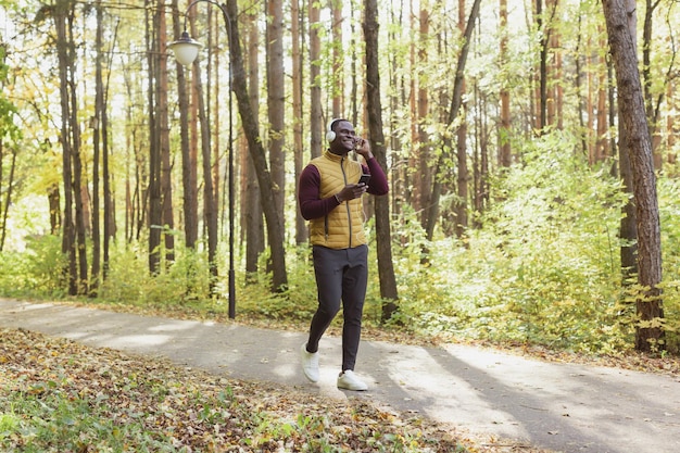 African american man listens music in spring park copy space and place for advertising gadget app