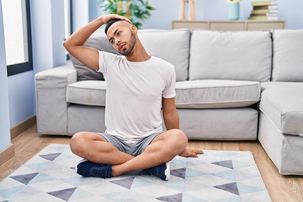 African american man stretching neck at home