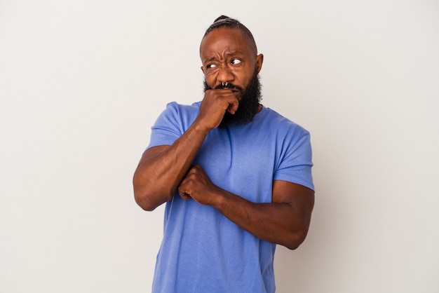 African american man with beard isolated on pink background confused, feels doubtful and unsure.