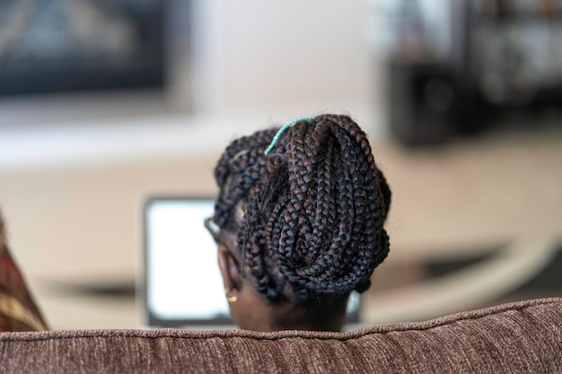 African American Nigerian woman working on her laptop from home