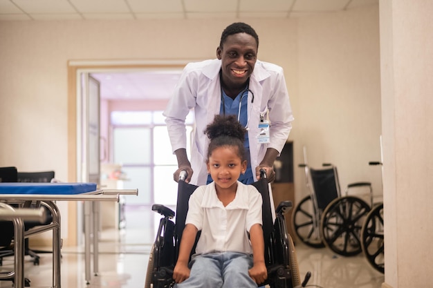 African American pediatric doctor with kids patient in hospital African American male pediatrician