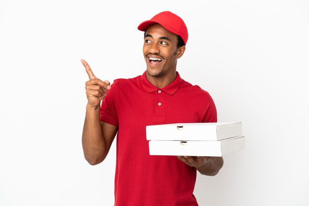 African American pizza delivery man picking up pizza boxes over isolated white wall intending to realizes the solution while lifting a finger up