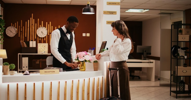 African american staff greets woman