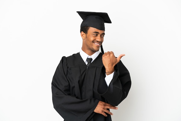 African American university graduate man over isolated white background pointing to the side to present a product