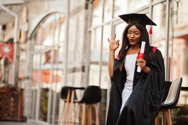 African American woman in a black robe at graduation