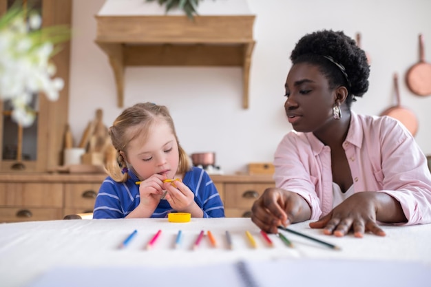 African american woman and a girl learning colors and drawing