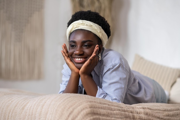 African american woman laying on bed and looking dreamy