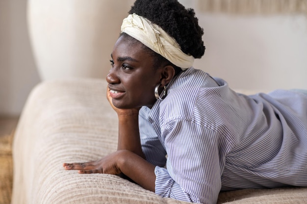 African american woman laying on bed and looking dreamy