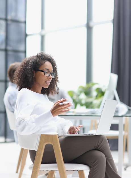 African american woman in the office sitting at a laptop