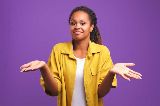 African american woman spreads arms to sides as sign sincere misunderstanding