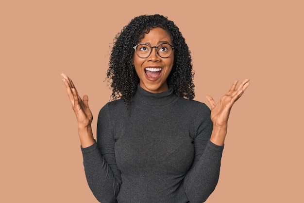 African American woman in studio setting screaming to the sky looking up frustrated