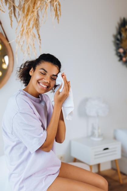 African american woman takes care of her skin in the bathroom