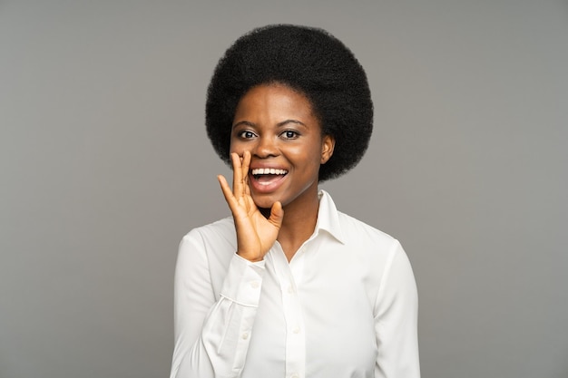 African American woman telling funny stories performs sketch at audition against grey studio