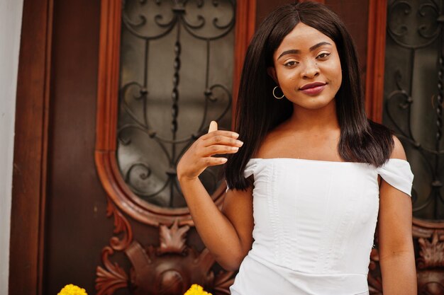 African american woman in white dress posed outdoorxA