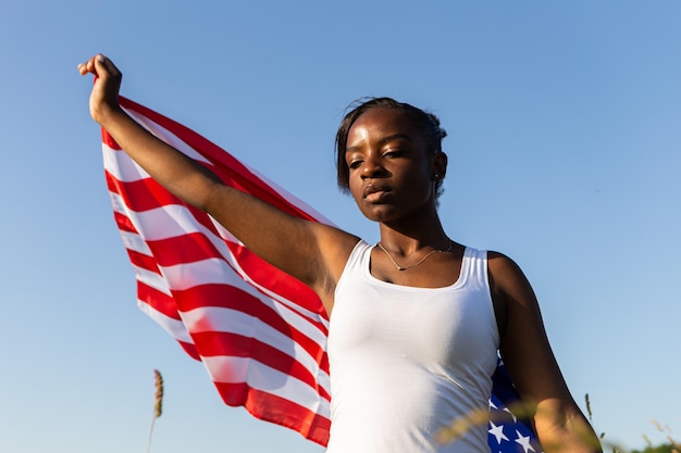 African american woman wrapped in american flag