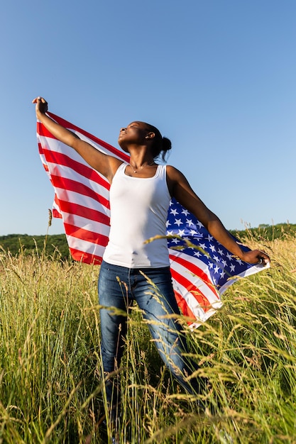 African american woman wrapped in american flag