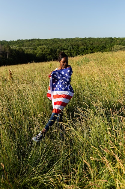 African american woman wrapped in american flag