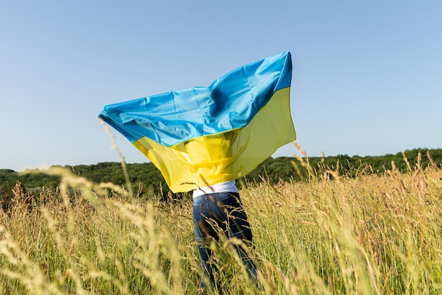 African american woman wrapped in ukrainian yellow blue flag national symbol of Ukraine