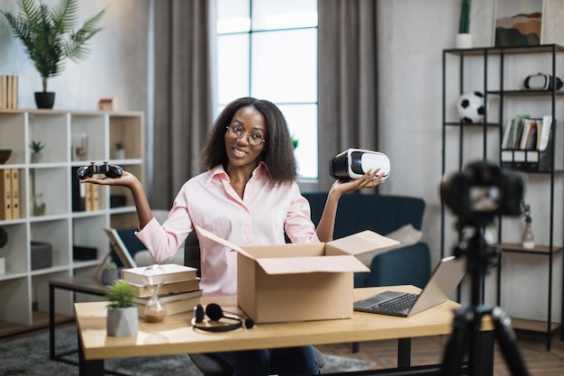 African blogger recording video while opening box