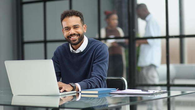 African businessman working on a laptop in an office