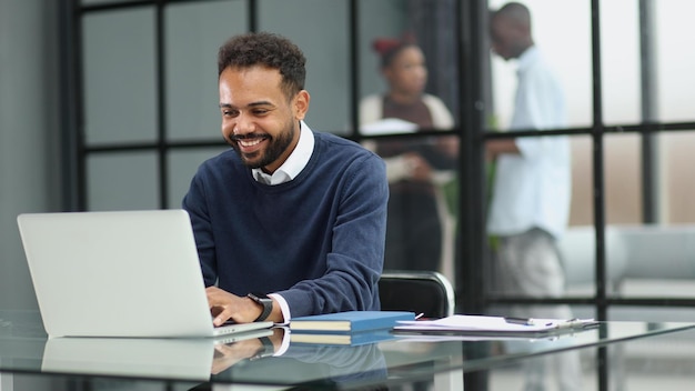 African businessman working on a laptop in an office