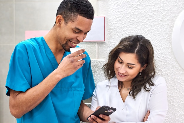 African and caucasian dentists on coffee break