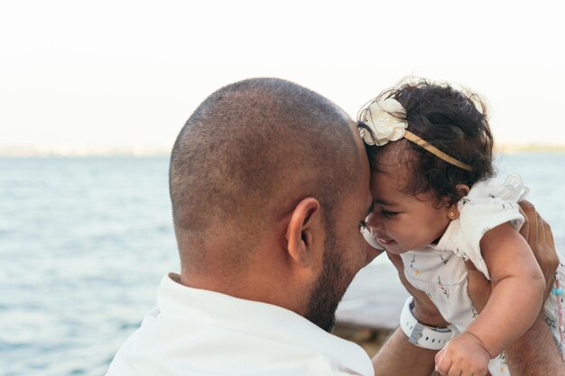 African dad plays with his baby