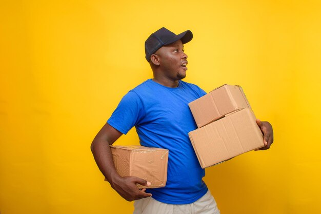 An African delivery or dispatch man carrying boxes and wearing a