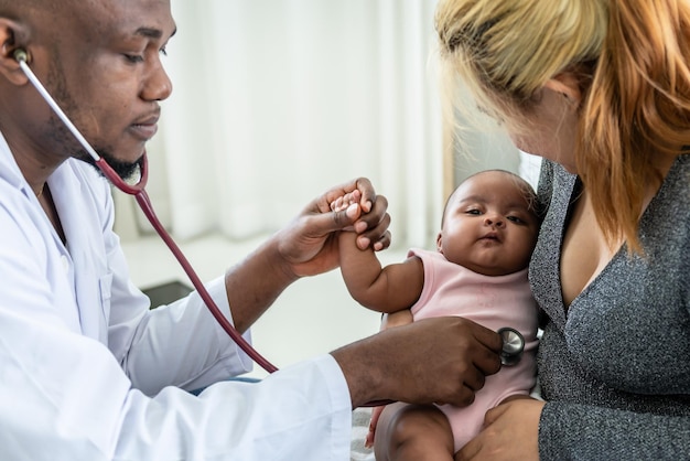 African doctor using a stethoscope checking the respiratory system and heartbeat baby newborn