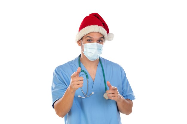 African doctor wearing a Christmas hat at coronavirus time isolated on a white wall