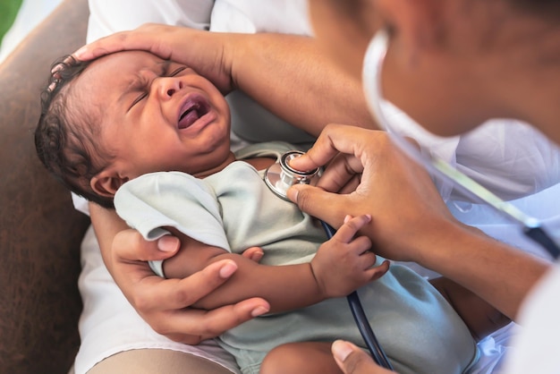 African doctor woman using a stethoscope checking the respiratory system and heartbeat