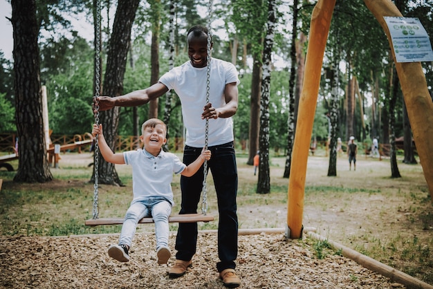 African Father Swinging Son Adopted Child Laughs