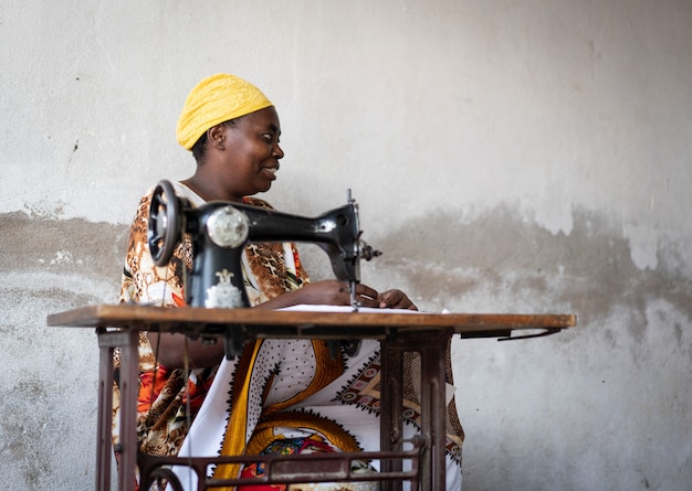 African female tailor working on sewing machine