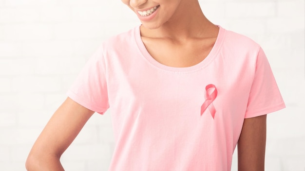 African Girl With Pink Ribbon On TShirt Posing White Background