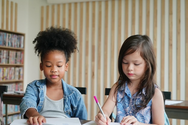 African kids drawing and do homework in classroom young girl happy funny study at school