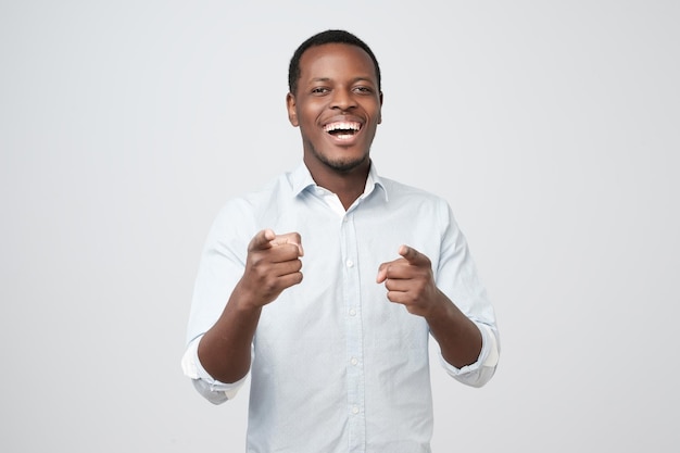 African man laughing and pointing finger at you