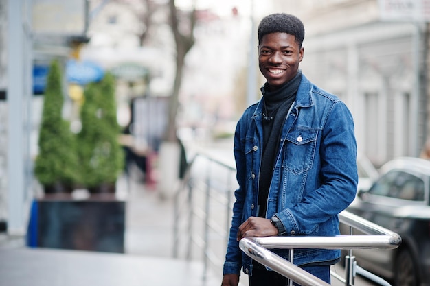 African man wear on jeans jacket posed outdoor