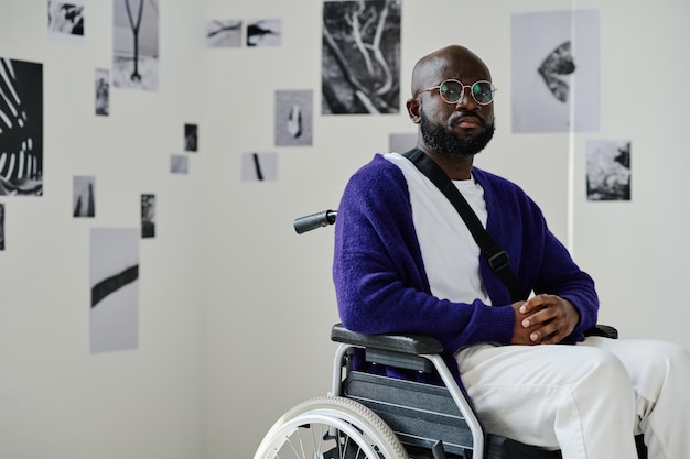 African man in wheelchair visiting art gallery