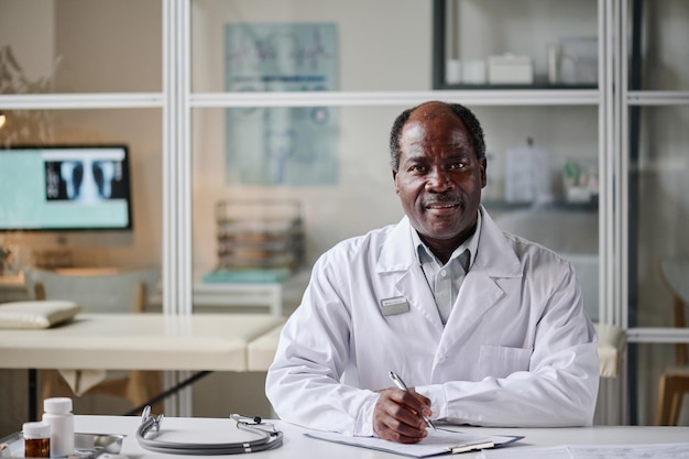 African pediatrician working at his workplace