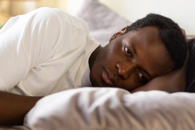 African tired man cannot sleep from insomnia