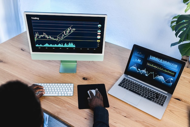 African trader studying stock market at home office - Focus on right hand